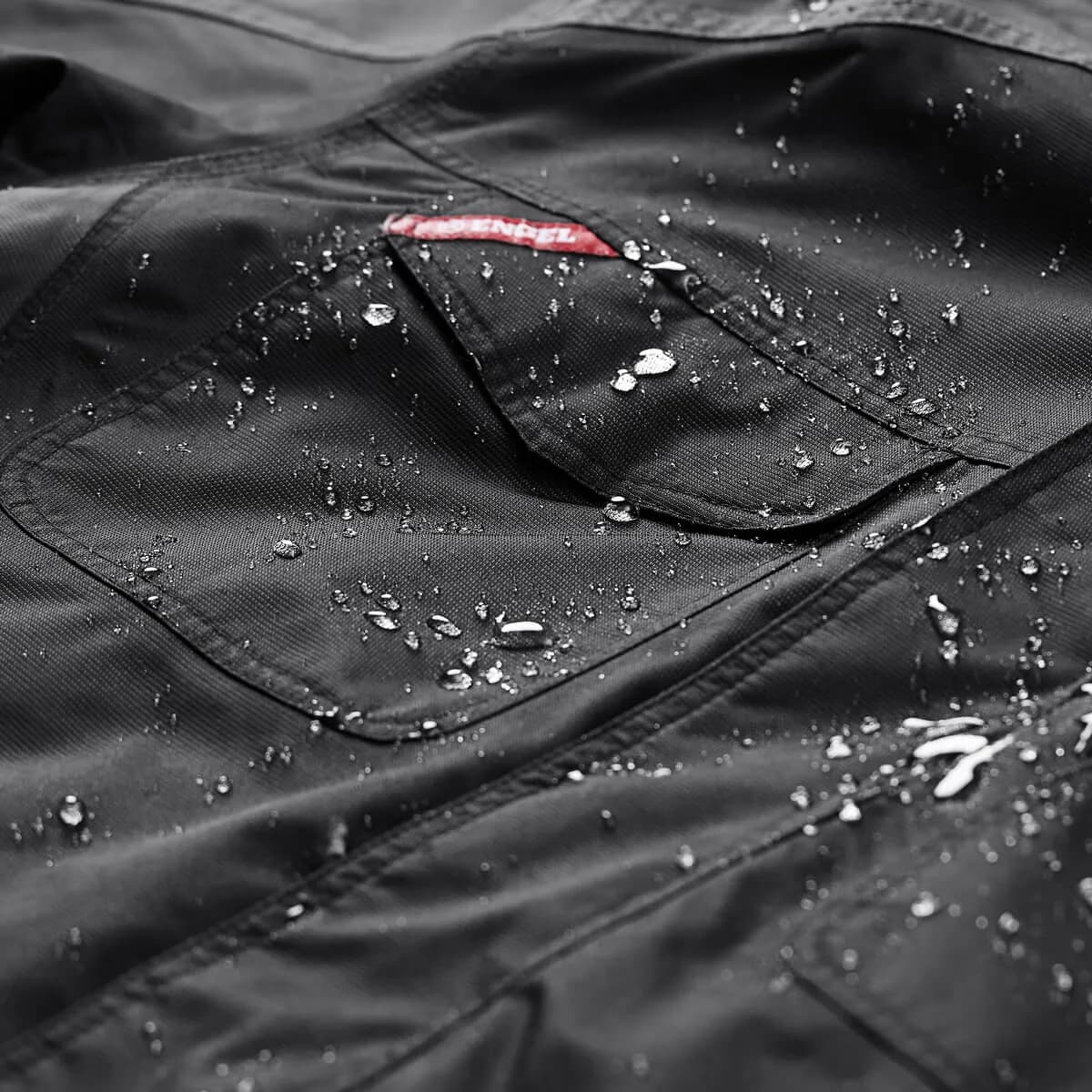 Professional waterproof workwear jacket with water droplets demonstrating quality and durability