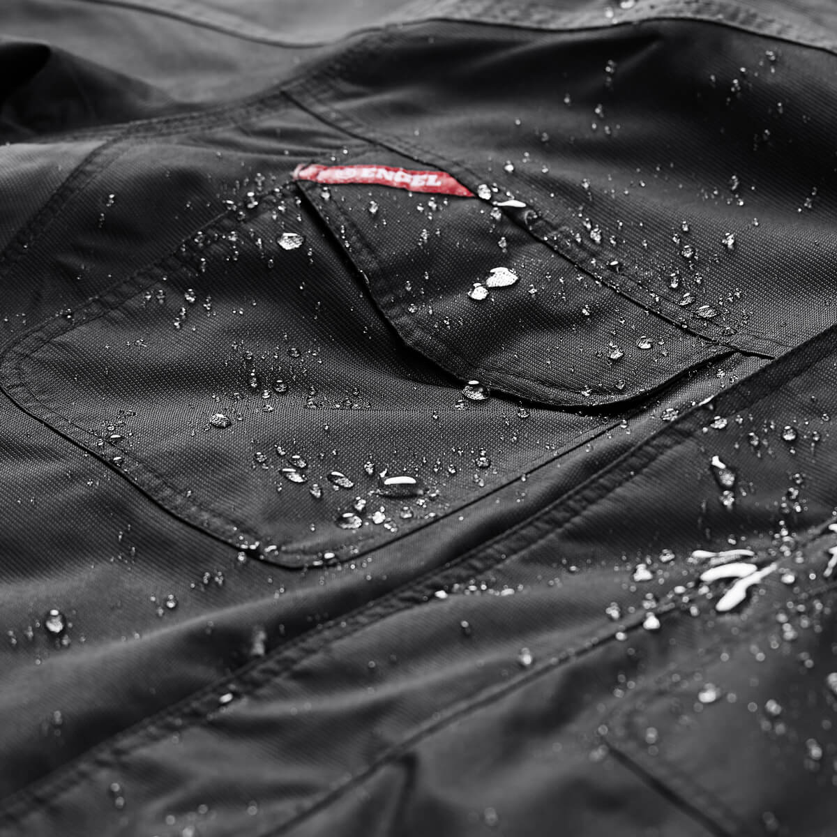 Professional waterproof workwear jacket with water droplets demonstrating quality and durability